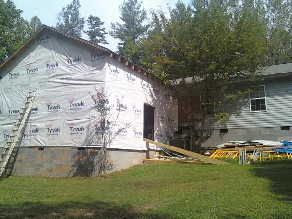 Tyvek wrapped gable on a new room addition beside an existing home in Avalon