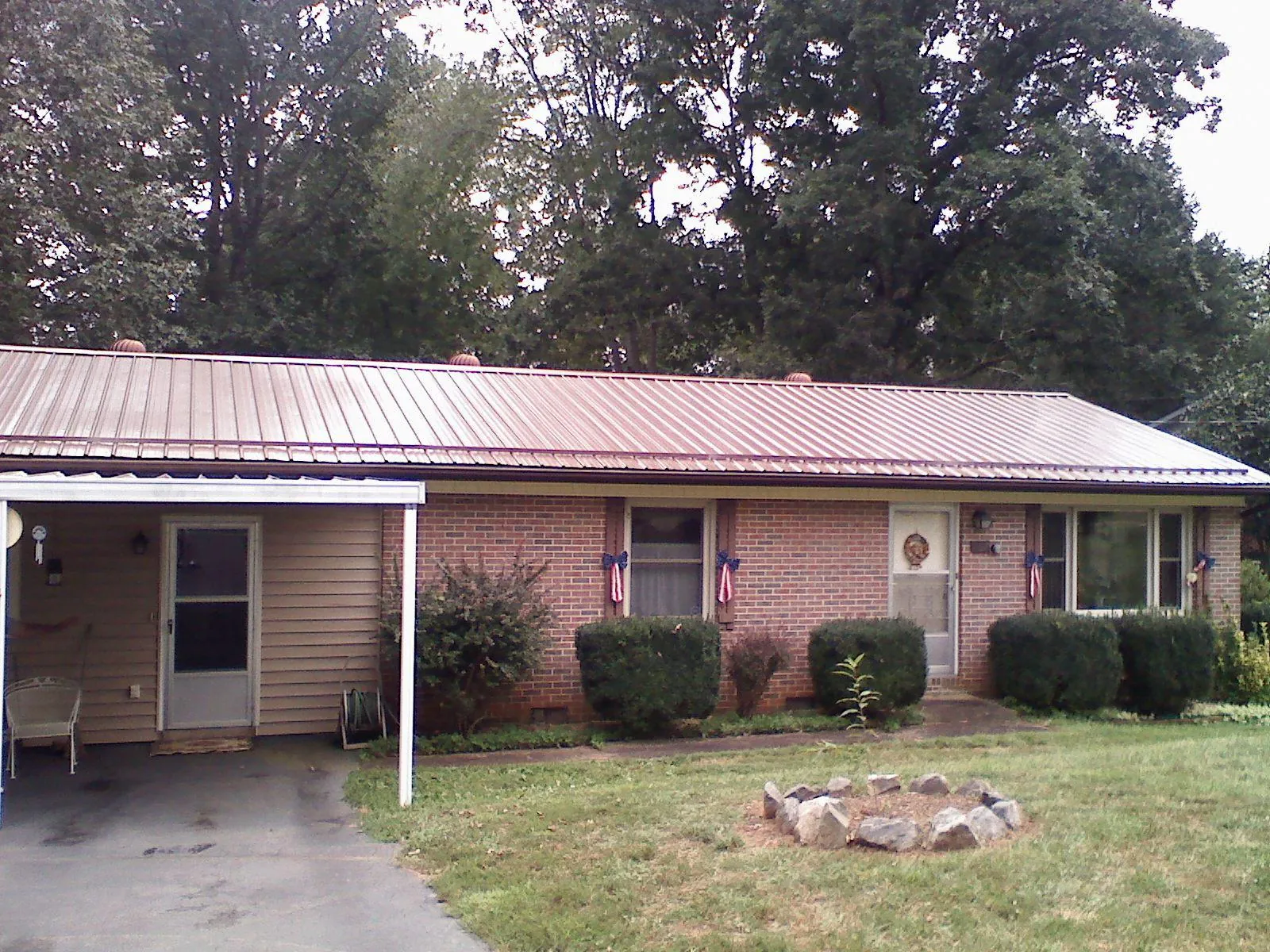 Bronze metal roof and carport on a brick ranch home — Roof Repair work by our crew in Avalon